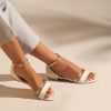 Flat leather sandals in white and gold
