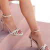 Heeled leather sandals in white and gold