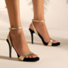 Heeled leather sandals in black and gold