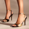 Heeled leather sandals in black and gold